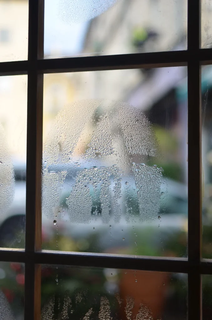 Foggy double pane window glass with condensation trapped between the panes